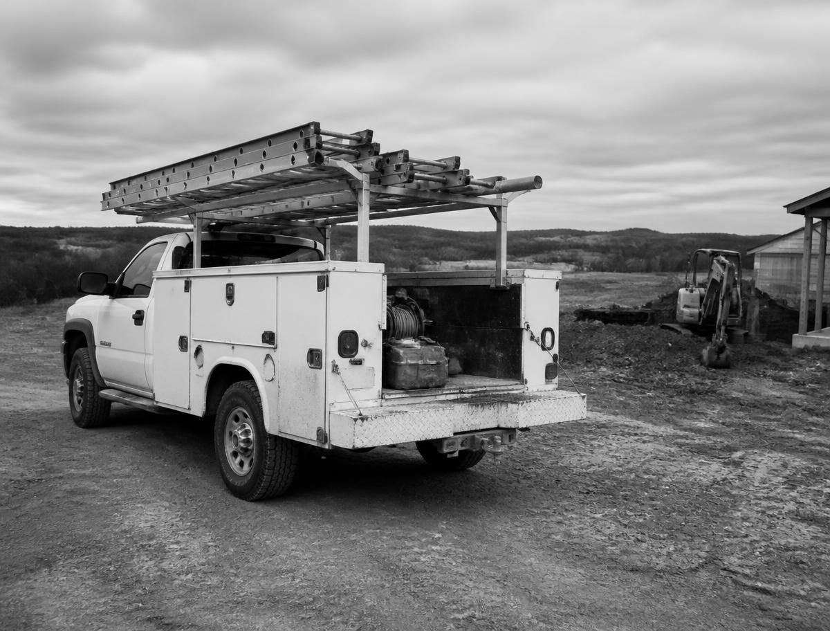 Service truck parked at a rural job site